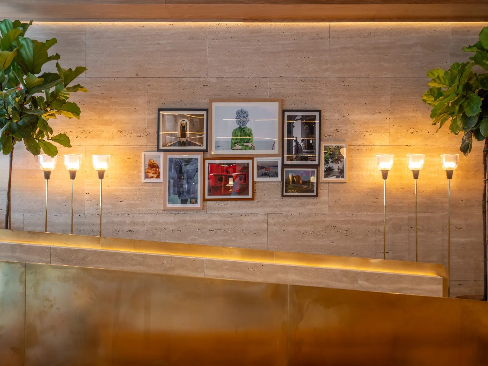 Reception area at Brown’s Avenue Hotel in Lisbon, with slender lamps framing a wall of photographs