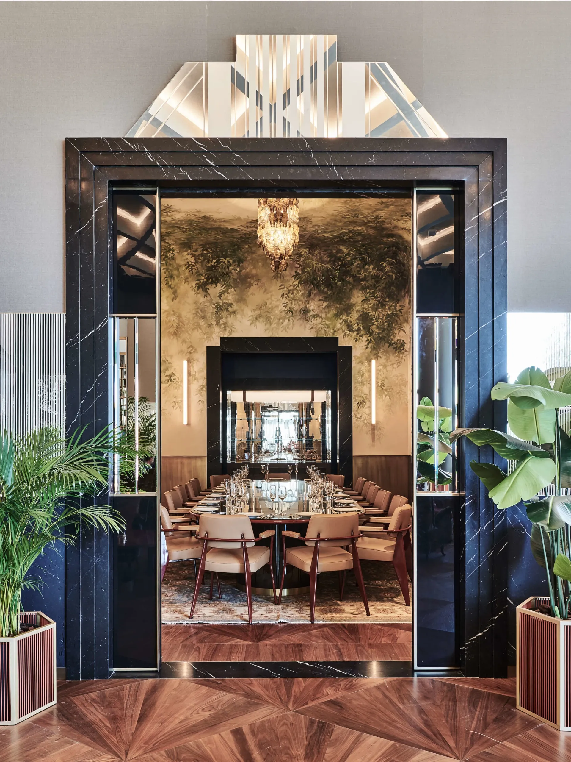 View through a dark doorway into a richly furnished room at The Arts Club Dubai