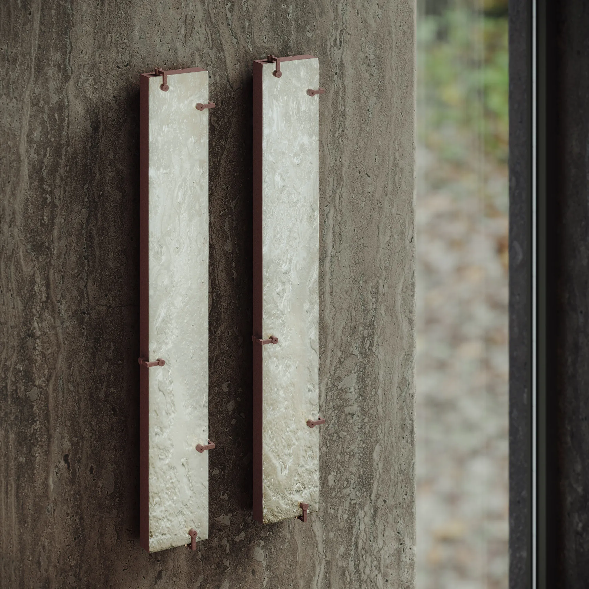 Pair of illuminated Agraphe wall lamps mounted on a textured stone wall
