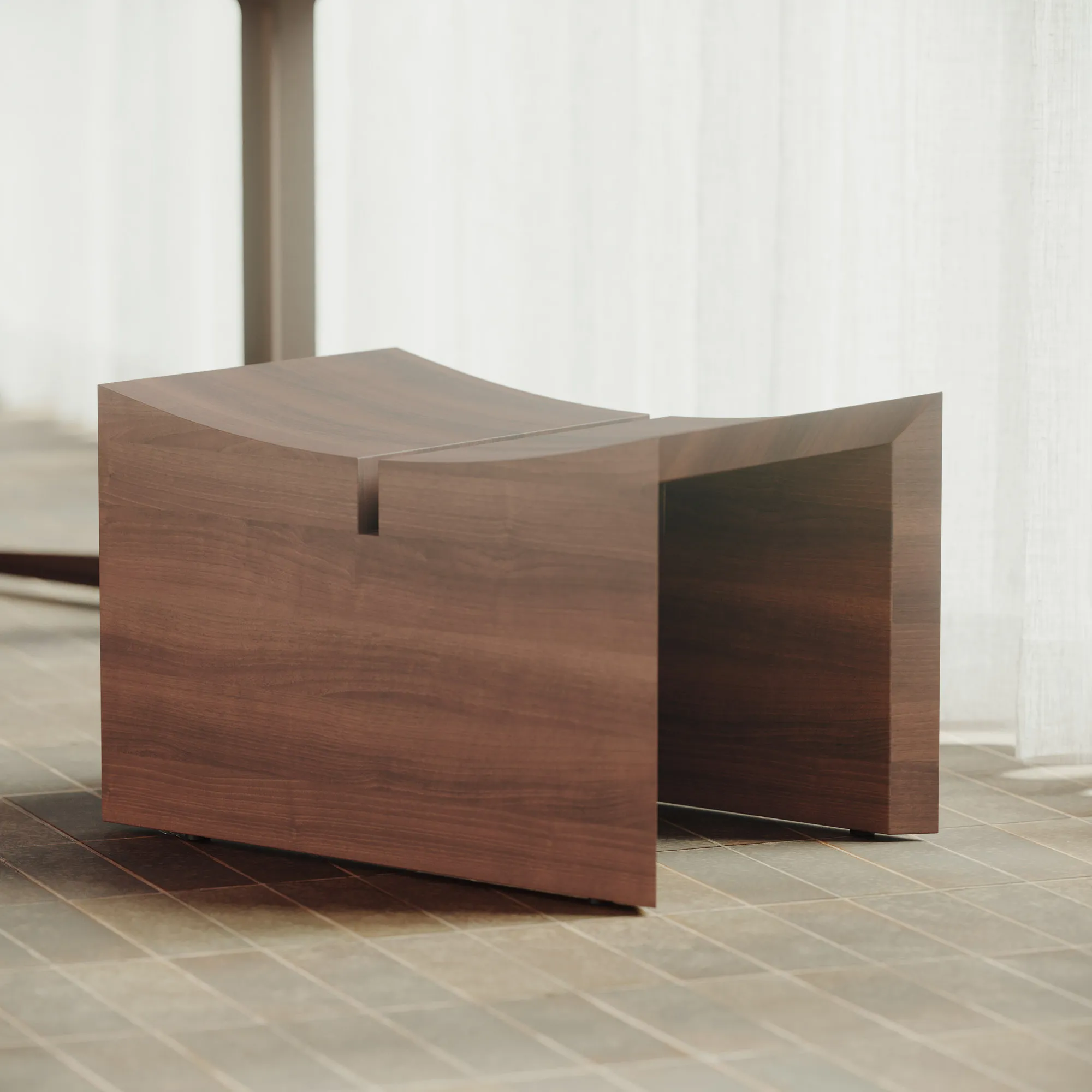 Élysée low stool in satin walnut beside a softly lit curtain