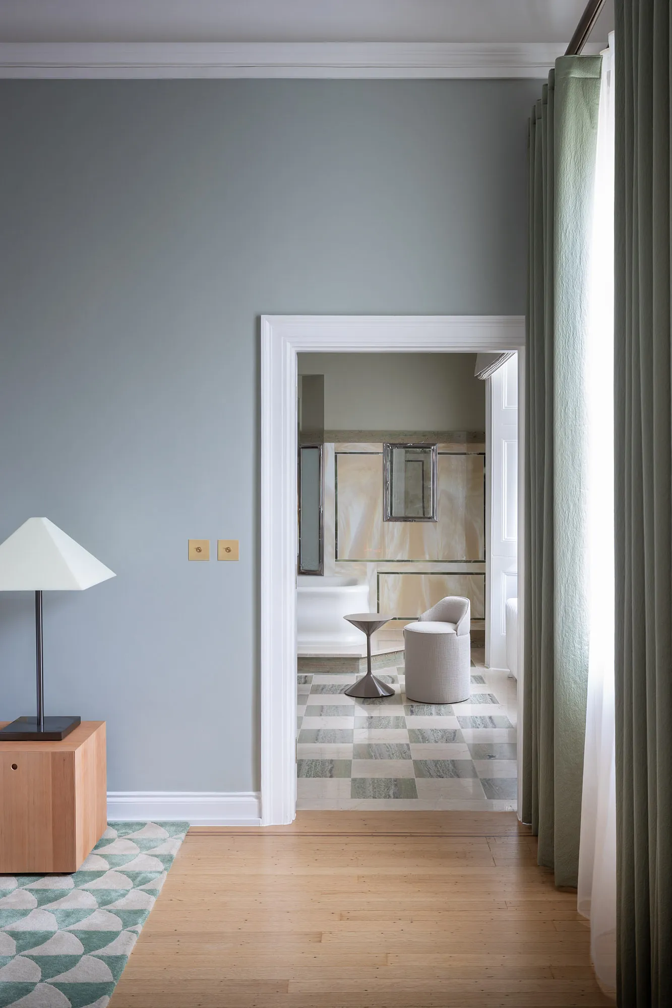 Blue-grey hall opening onto another room in the ambassador’s residence