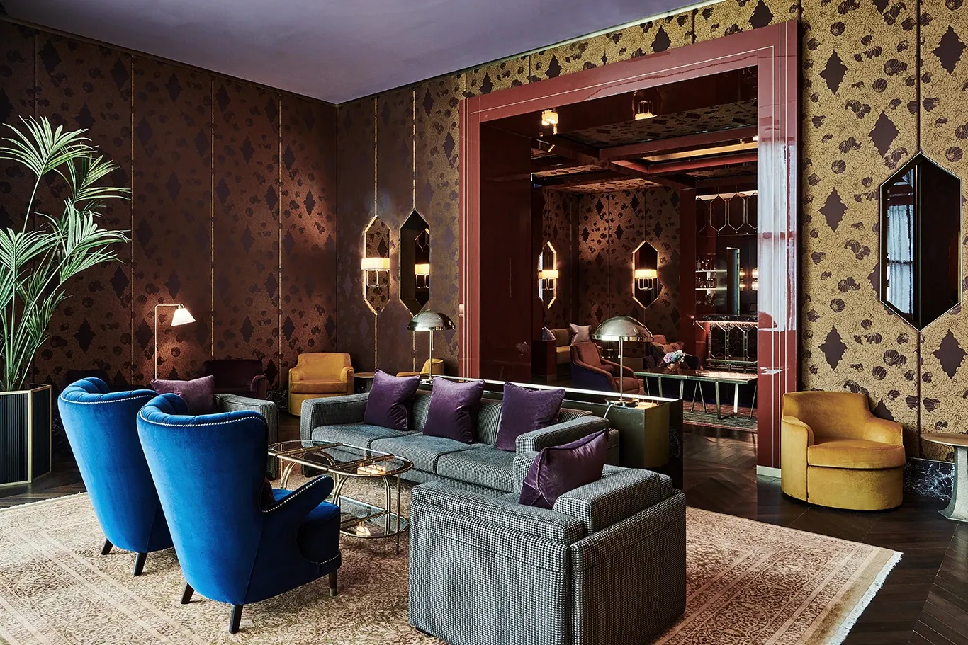 Blue armchairs and sofas in a patterned lounge at The Arts Club Dubai