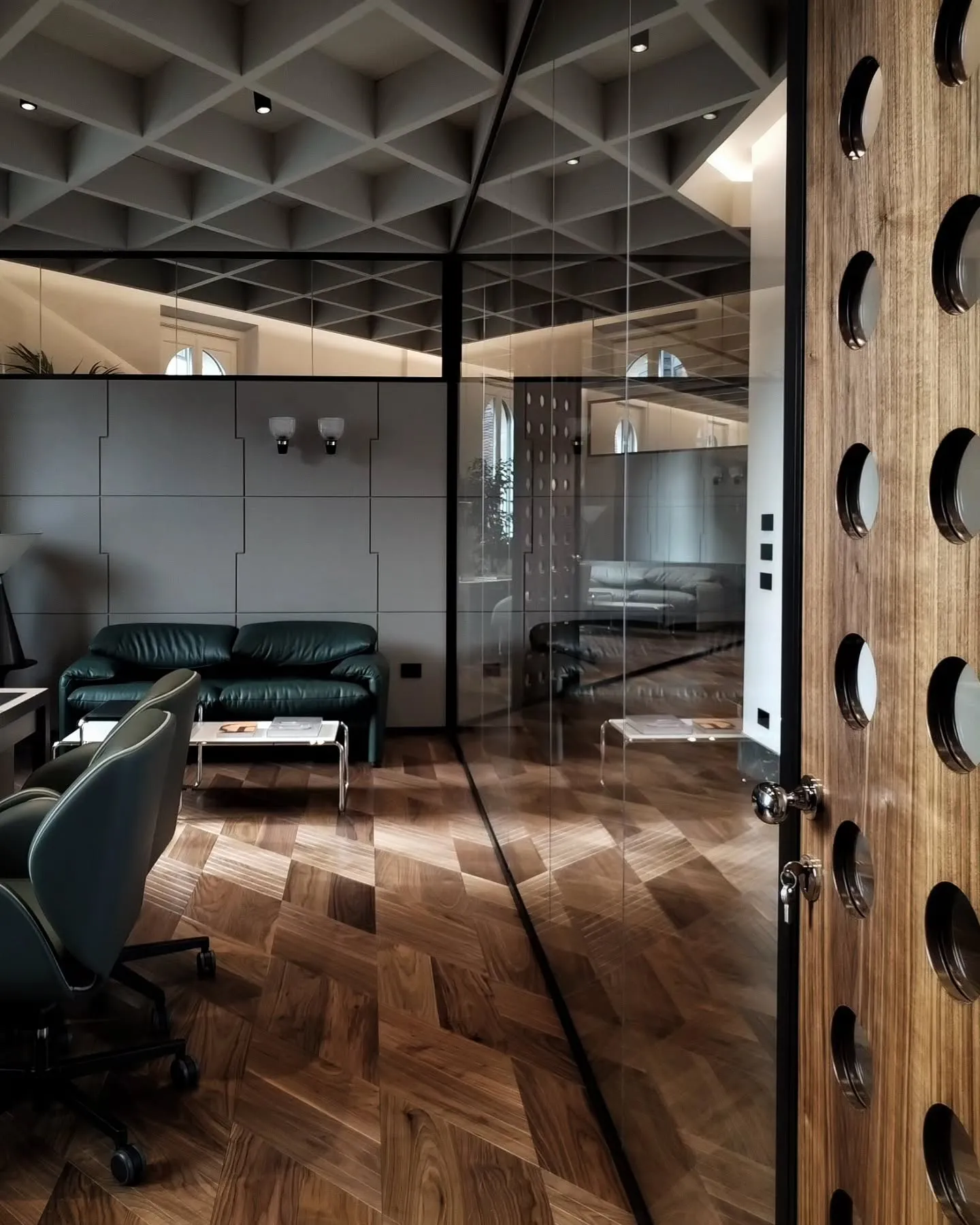 View past carved timber doors into the glass-partitioned Christofferson, Robb offices