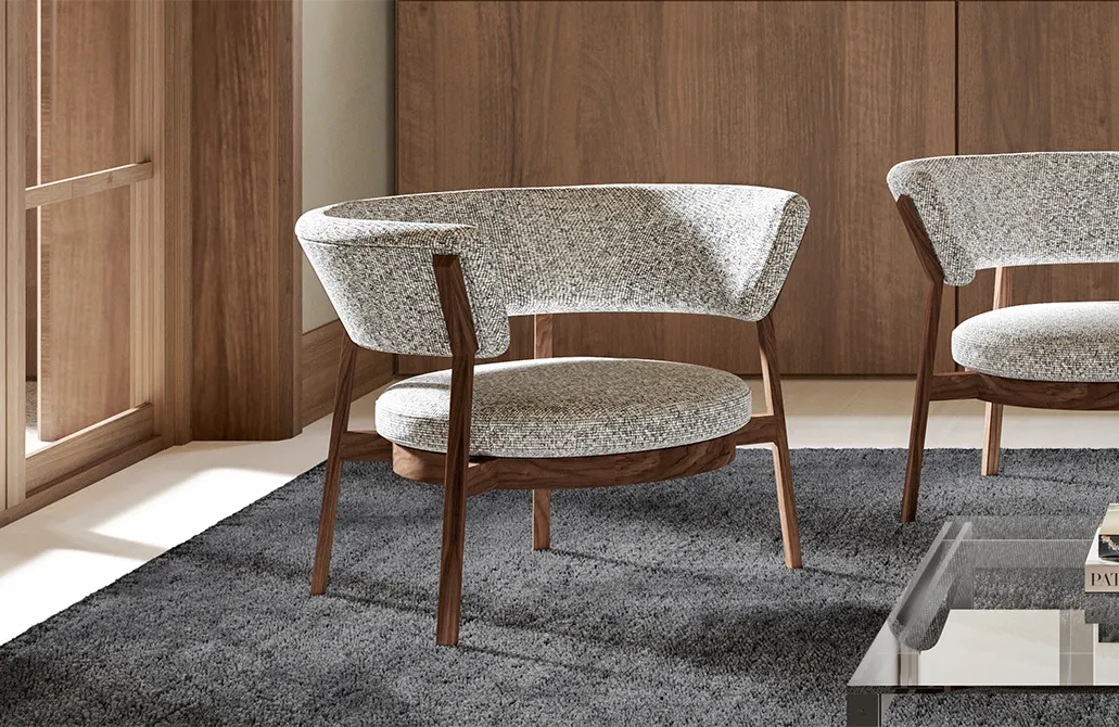 Pink upholstered seating and a slim round table in a colour-blocked TATO interior