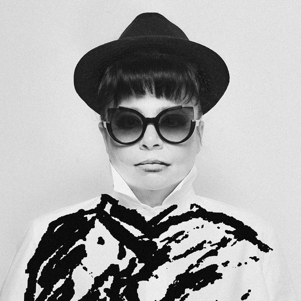 Black-and-white portrait of Milanese designer Lorenza Bozzoli wearing a hat and sunglasses